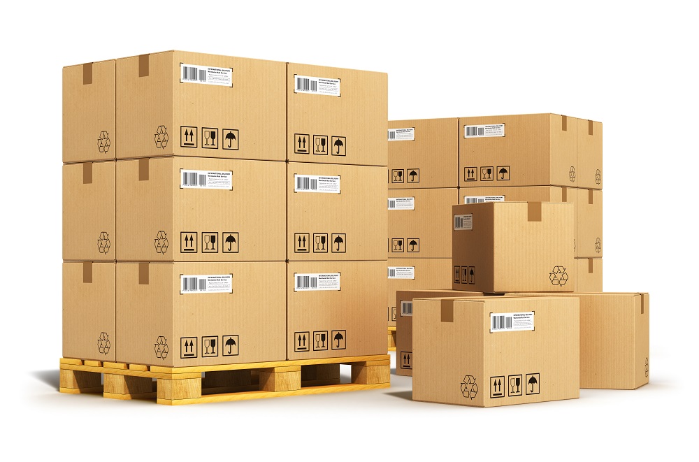 Creative cargo delivery and transportation logistics storage warehouse industry business concept: group of stacked corrugated cardboard boxes on wooden shipping pallets isolated on white background