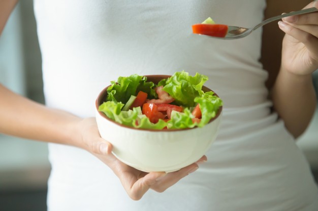 female-hands-holding-bowl-green-salad_1163-2250