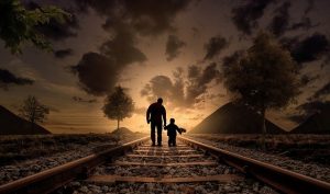 A father and son walking along railway