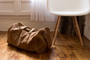 A chair and some luggage next to it.