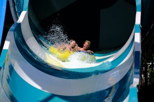 A couple going down a slide in one of the water parks in Long Island.