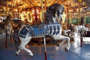 Carousel with horses and various colorful lights.