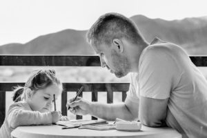 Father and daughter drawing and talking.