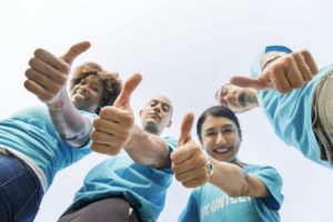 A group of people showing thumbs up because they know hiring movers is inevitable to organize your business relocation properly.