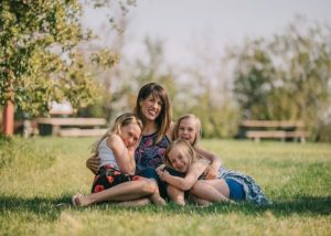 Mother hugging her three daughters