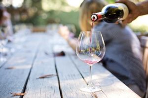 Red wine is poured into a wine glass